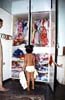 child in front of cupboard