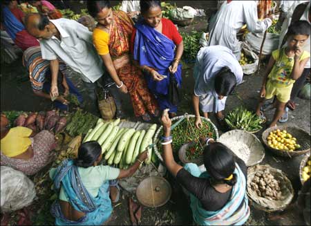 People buy vegetable at a village market.