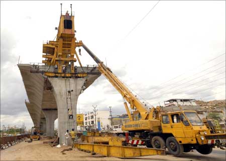 Labourers work at a flyover undergoing construction in Hyderabad.