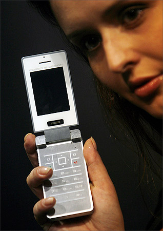 A model displays P'9521, the first Porsche Design mobile phone, during its India launch.