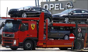 A truck loaded with cars leaves the Opel assembly plant in Antwerp, Belgium.