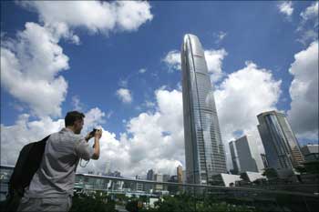 A visitor takes a picture in front of Two IFC, Hong Kong's highest commercial building.