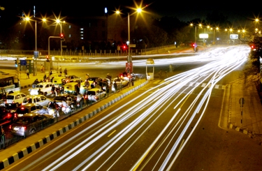 Vehicular traffic moves on a street in New Delhi.